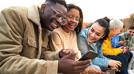 group-of-happy-diverse-teenagers-looking-at-phone.jpg